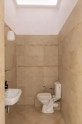 a bathroom with a toilet and a sink at Old Town św Jana by Downtown Apartments in Kraków