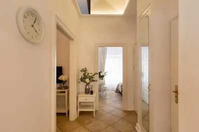 a bedroom with a bed and a door leading into a room at Old Town św Jana by Downtown Apartments in Kraków