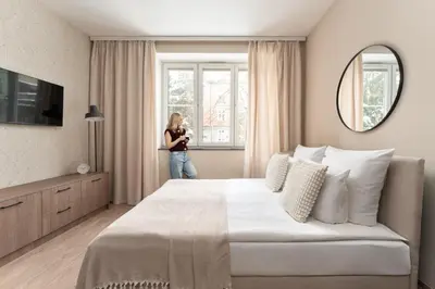 a woman standing in the kitchen of a apartment at Pułaskiego Boutique by Downtown Apartments in Kraków