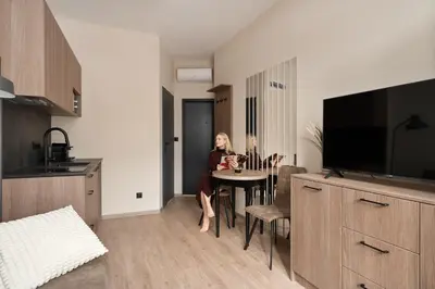 a bedroom with a bed and a table and a mirror at Pułaskiego Boutique by Downtown Apartments in Kraków