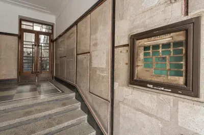 an empty room with stairs and a wall with a window at Pułaskiego Boutique by Downtown Apartments in Kraków