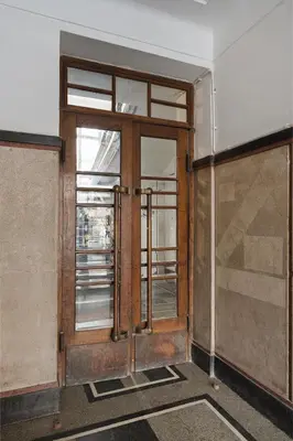 an open door of a building with a window at Pułaskiego Boutique by Downtown Apartments in Kraków