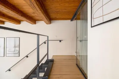 a staircase in a house with a wooden ceiling at 2 bedroom apartment - Grodzka Street - City Center in Kraków
