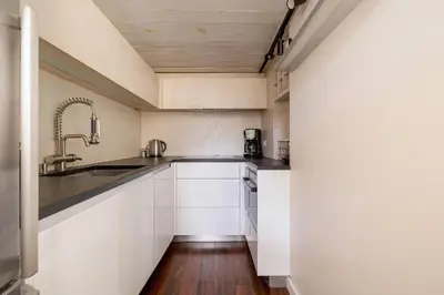 a kitchen with white cabinets and a sink at 2 bedroom apartment - Grodzka Street - City Center in Kraków