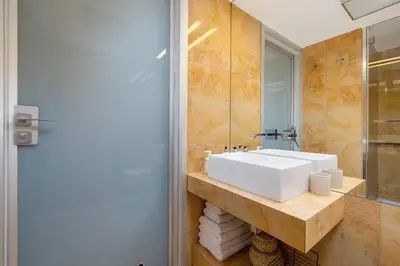 a bathroom with a white sink and a mirror at 2 bedroom apartment - Grodzka Street - City Center in Kraków