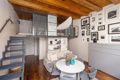 a living room with a staircase and a table and chairs at 2 bedroom apartment - Grodzka Street - City Center in Kraków