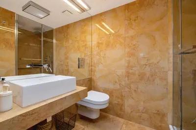 a bathroom with a toilet and a sink and a shower at 2 bedroom apartment - Grodzka Street - City Center in Kraków