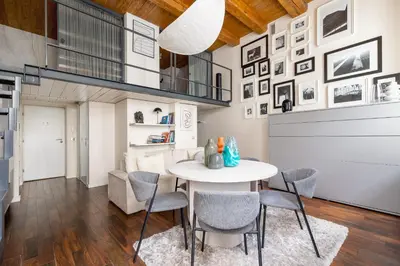 a dining room with a white table and chairs at 2 bedroom apartment - Grodzka Street - City Center in Kraków