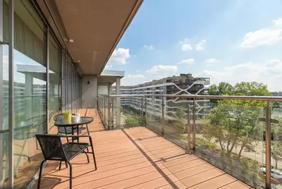 a balcony with a table and chairs on a building at Tasteful Apartment in Cracow with Parking & Balcony by Nolcegi Renters in Kraków