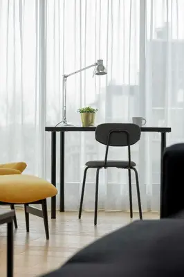 a desk with a chair and a lamp in a room at Tasteful Apartment in Cracow with Parking & Balcony by Nolcegi Renters in Kraków