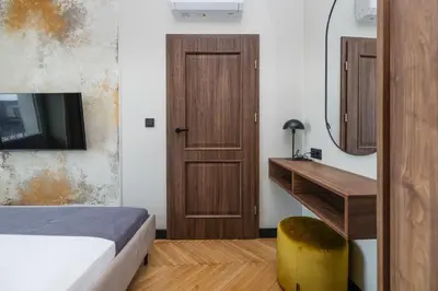 a bedroom with a bed and a desk and a mirror at 3 bedroom - Grodzka Street - Old Town in Kraków