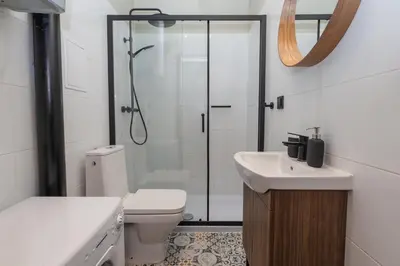 a bathroom with a shower and a toilet and a sink at 3 bedroom - Grodzka Street - Old Town in Kraków