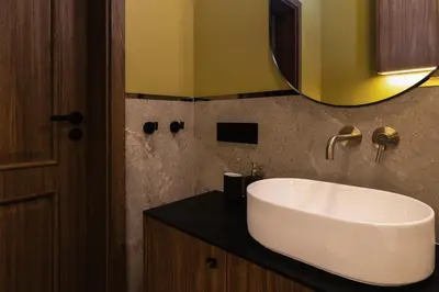 a bathroom with a white sink and a mirror at 3 bedroom - Grodzka Street - Old Town in Kraków