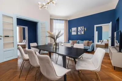 a kitchen with a table and chairs and a counter at 4-Bedroom apartment-Old Town-Św Gertrudy Street in Kraków