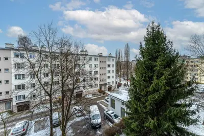 a christmas tree on a city street with buildings at Nowa Huta Charming Details Apartment by BookingHost in Kraków