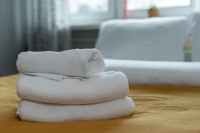 three towels stacked on top of each other on a table at Nowa Huta Charming Details Apartment by BookingHost in Kraków