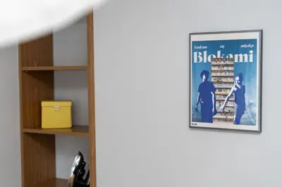a movie poster hanging on a wall next to a shelf at Nowa Huta Charming Details Apartment by BookingHost in Kraków