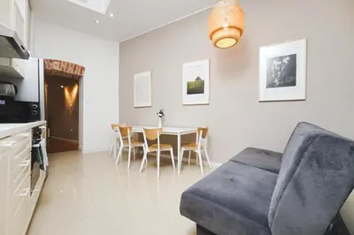 a living room with a couch and a table at Old Town Sarego Apartment in Kraków