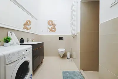 a laundry room with a washer and dryer at Old Town Sarego Apartment in Kraków