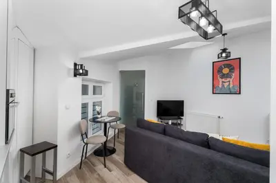 a living room with a couch and a table at Starowiślna Charming Studio by BookingHost in Kraków