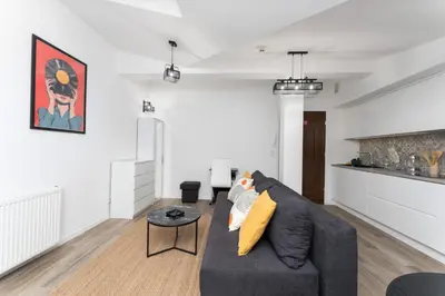 a living room with a couch and a table at Starowiślna Charming Studio by BookingHost in Kraków