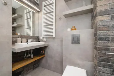 a bathroom with a sink and a toilet at 3-Bedroom apartment in Historic Kazimierz in Kraków