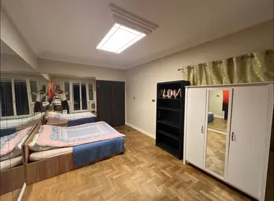 a large room with two beds and a window at 5 min from city center by feet in Kraków