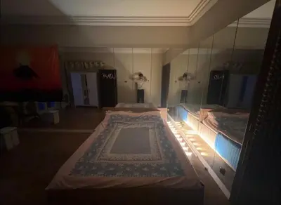 a room with two beds and a mirror at 5 min from city center by feet in Kraków