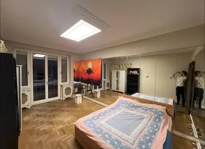 a room with a bed and a painting on the wall at 5 min from city center by feet in Kraków