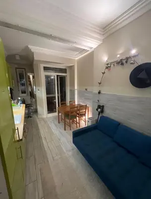 a living room with a blue couch and a table at 5 min from city center by feet in Kraków