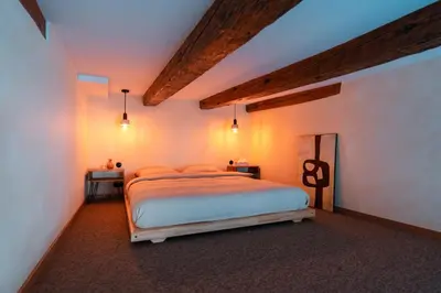 a bedroom with a bed with lights on it at Cozy studio in the center of Krakow in Kraków