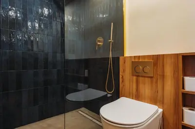 a bathroom with a toilet and a glass shower at Cozy studio in the center of Krakow in Kraków
