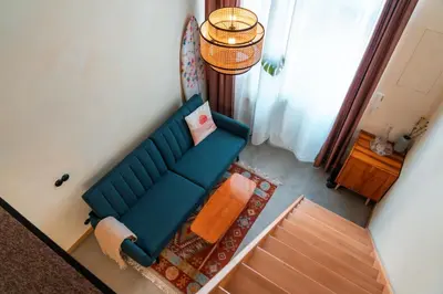 an overhead view of a living room with a blue couch at Cozy studio in the center of Krakow in Kraków