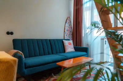 a blue couch in a living room with a table at Cozy studio in the center of Krakow in Kraków