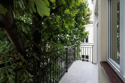 a balcony with a tree and a fence at Urban Retreat - Krowoderska Apartment - by Upstairs in Kraków
