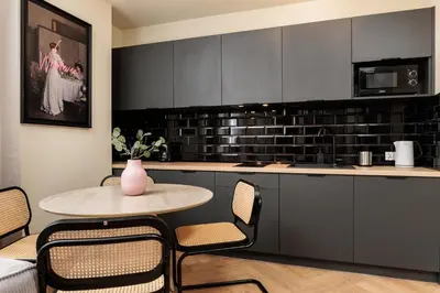 a kitchen with a table and chairs and a counter at Urban Retreat - Krowoderska Apartment - by Upstairs in Kraków