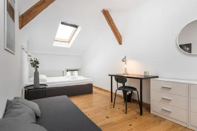 a bedroom with a bed and a desk and a table at Old Town Loft - 7 Bedroom Apartment - by Upstairs in Kraków