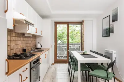 a kitchen with a table and chairs and a counter top at Old Town Loft - 7 Bedroom Apartment - by Upstairs in Kraków