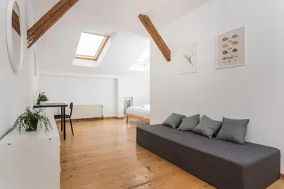a living room with a couch and a table at Old Town Loft - 7 Bedroom Apartment - by Upstairs in Kraków