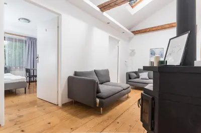 a living room with a couch and a tv at Old Town Loft - 7 Bedroom Apartment - by Upstairs in Kraków