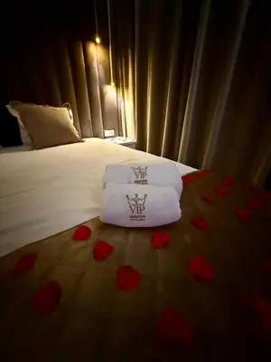 a white robe hanging on a wall next to a closet at Starowiślna Prestige VIP Apartamenty Jacuzzi in Kraków