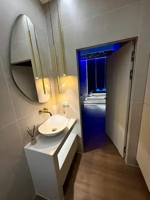 a bathroom with a sink and a mirror at Starowiślna Prestige VIP Apartamenty Jacuzzi in Kraków