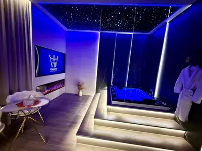 a living room with a fireplace with a tv above it at Starowiślna Prestige VIP Apartamenty Jacuzzi in Kraków