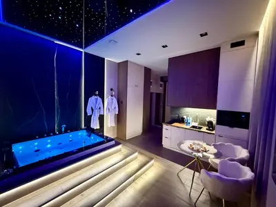 a kitchen with a pool in the middle of a room at Starowiślna Prestige VIP Apartamenty Jacuzzi in Kraków