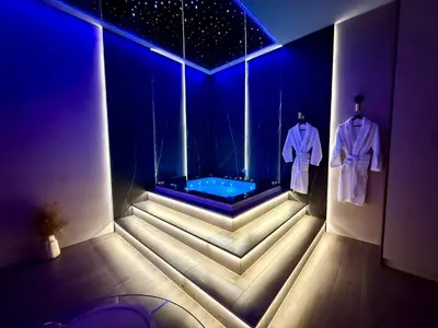 a hot tub in a room with a tv at Starowiślna Prestige VIP Apartamenty Jacuzzi in Kraków
