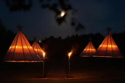 a room with benches and tables in a tent at Moon Glamping