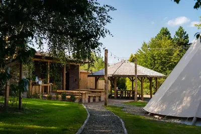 a garden with a picnic table and a pavilion at Moon Glamping