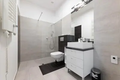 a bathroom with a toilet and a sink and a shower at plac Na Groblach 5 by Homeprime in Kraków