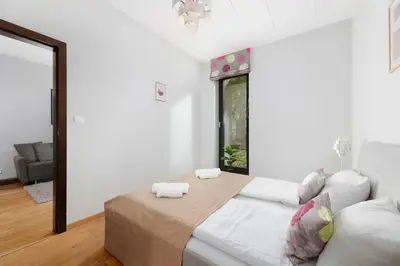 a bedroom with a large bed with two towels at plac Na Groblach 5 by Homeprime in Kraków