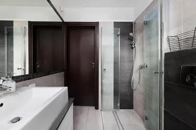 a bathroom with a white sink and a shower at plac Na Groblach 5 by Homeprime in Kraków